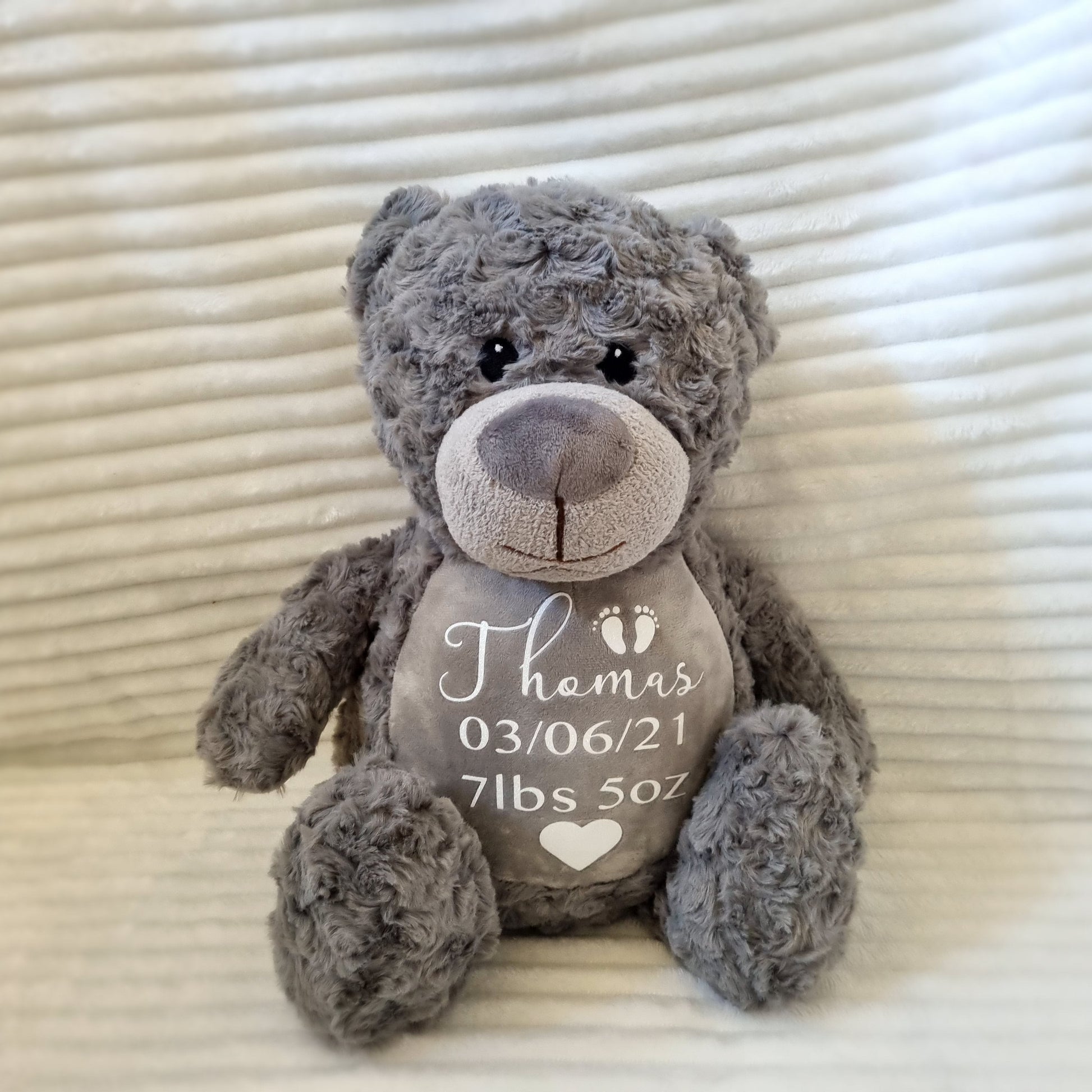 Gray plush teddy bear with embroidered birth weight details on belly