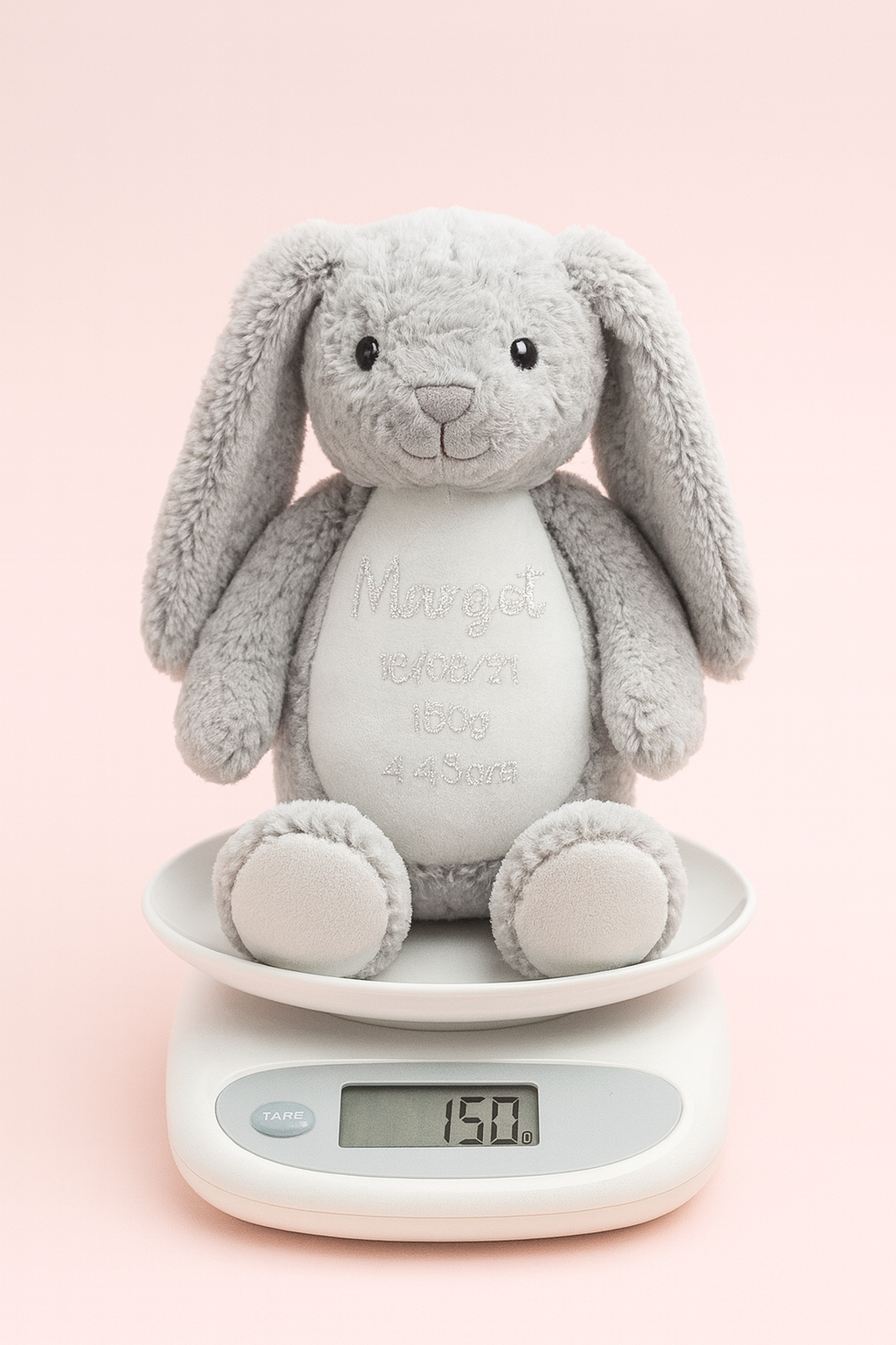 Soft grey bunny plush on scale for exact birth weight keepsake